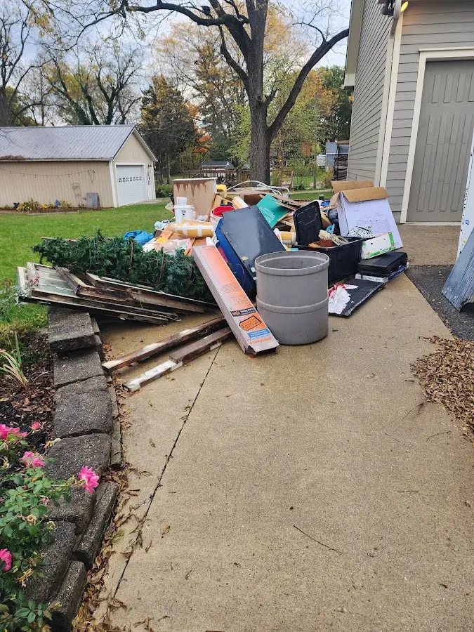 Dumpster being loaded with debris for Commercial Dumpster Rental in Stevens Point